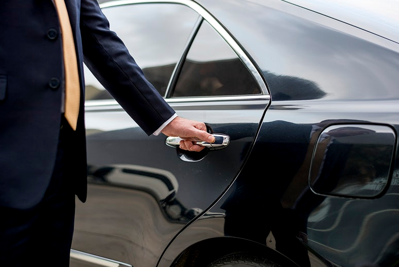 man in suit opening the car door